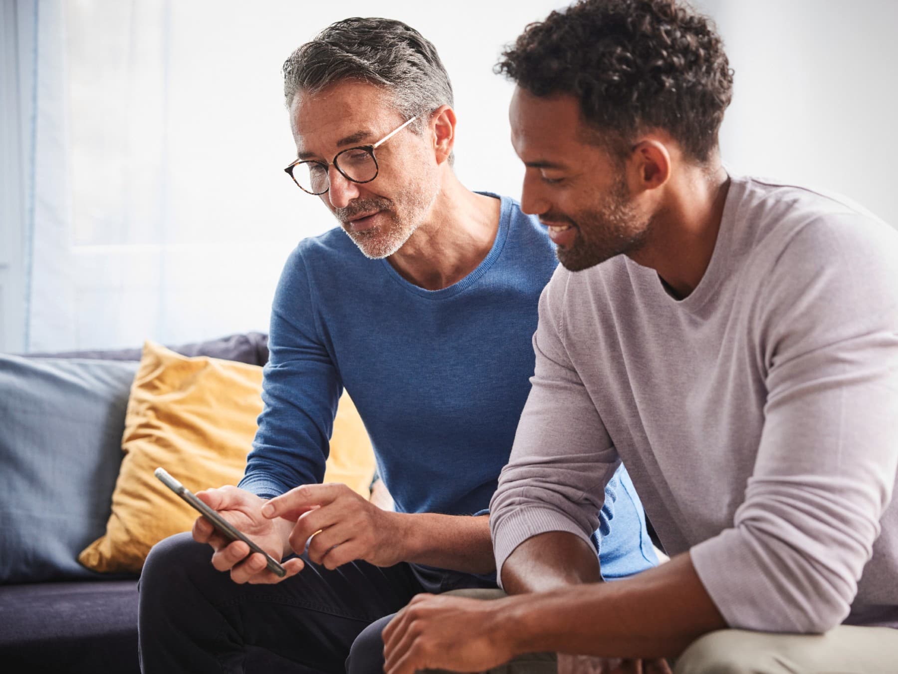 Zwei Personen, die gemeinsam auf ein Smartphone schauen