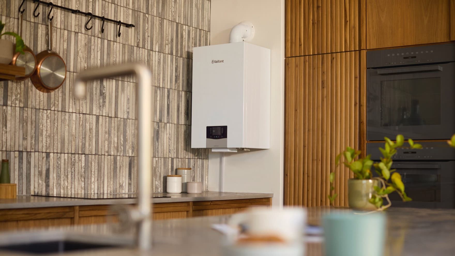 Eine Vaillant Gasheizung hängt an einer Wand über einer Küchenzeile.